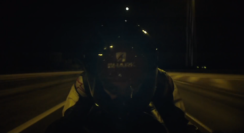 An alien motorcyclist monitoring the protagonist